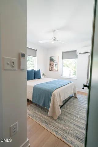 a bedroom with a bed and wooden floor