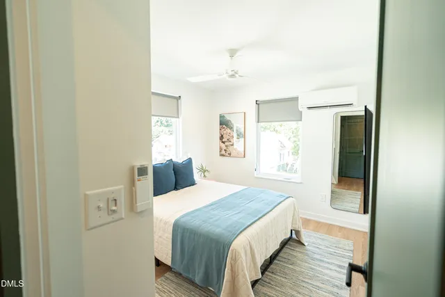 a bedroom with a bed and a window