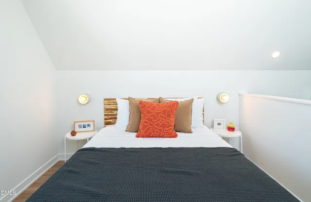 a bedroom with a bed and a night stand