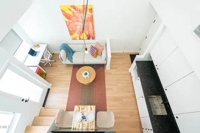 a view of a living room with furniture and wooden floor