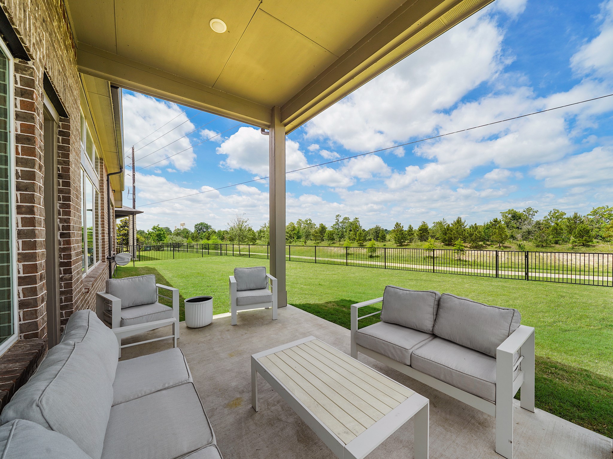 5802 Emerald Ranch Lane Fulshear, TX 77441 - Photo 41 of 45 The covered back patio creates the perfect outdoor retreat with plenty of room for lounging and entertaining while overlooking the expansive backyard and open views beyond. The existing gas connection also offers excellent potential for a future outdoor kitchen or enhanced entertaining space.