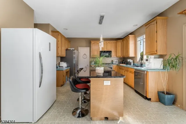 a bedroom with furniture a fireplace and a flat screen tv