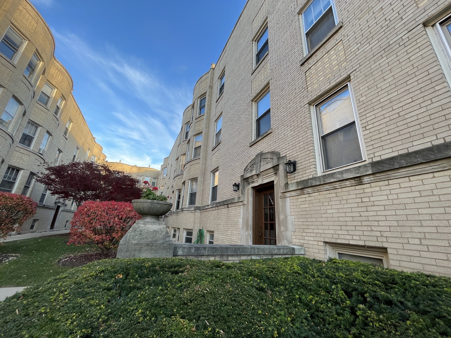 a view of a brick house with a yard