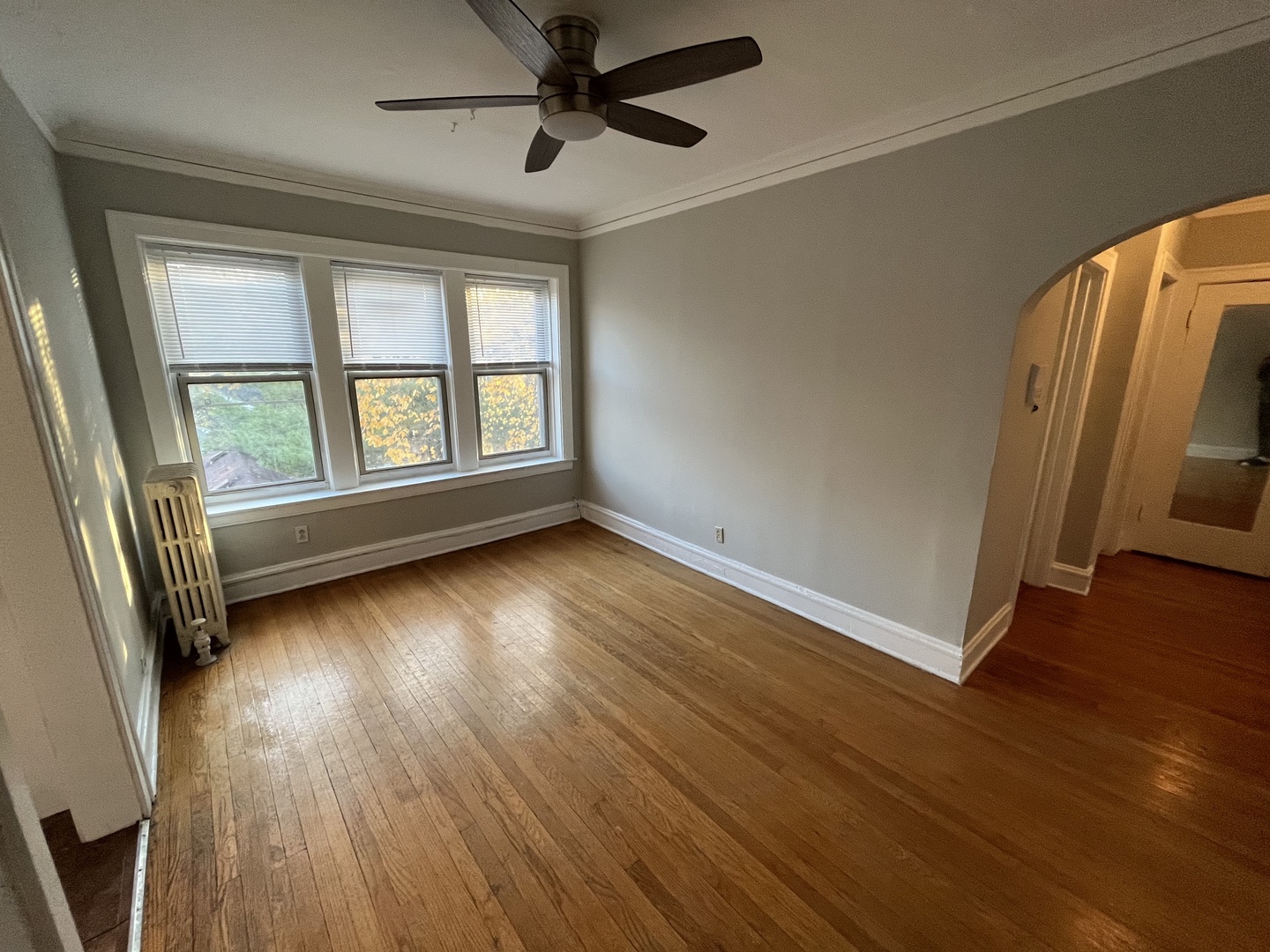 Undisclosed Address Chicago, IL 60625 - Photo 4 of 13 an empty room with wooden floor and windows