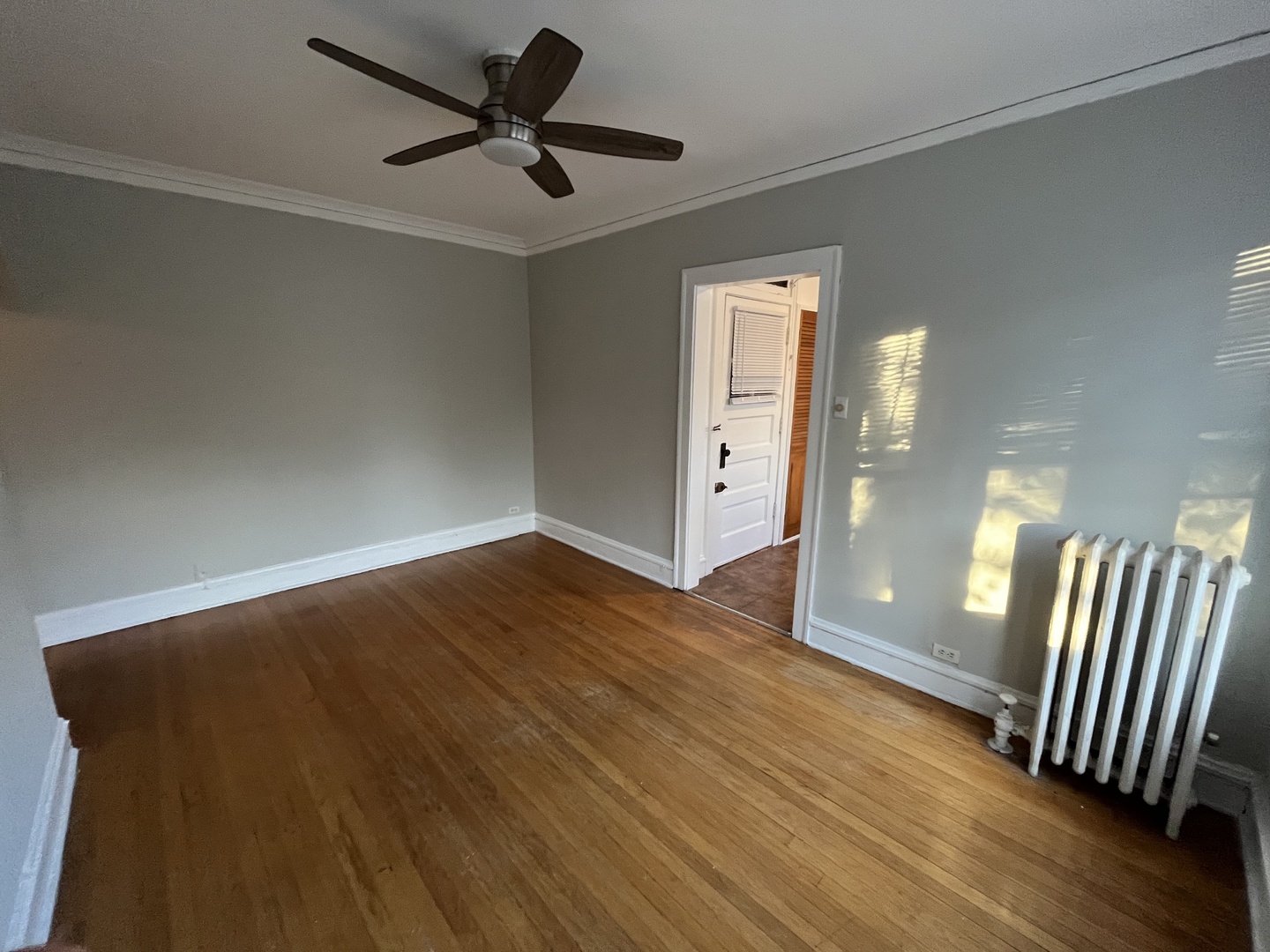 Undisclosed Address Chicago, IL 60625 - Photo 5 of 13 a view of an empty room with wooden floor and a ceiling fan