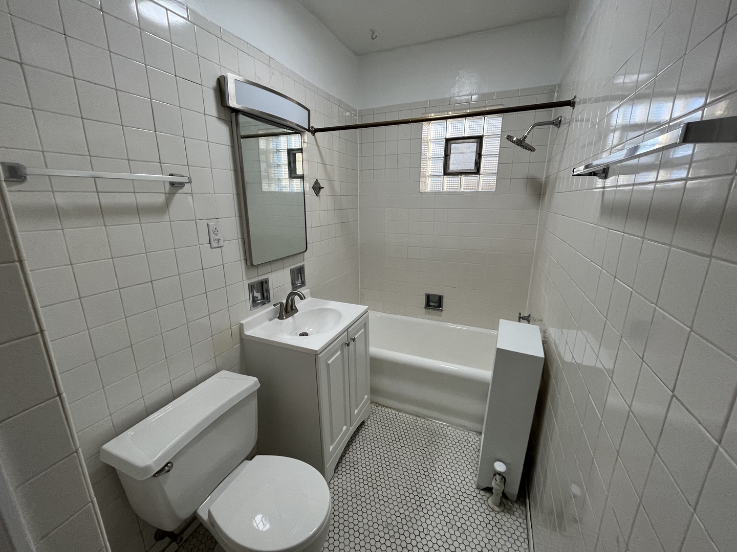 Undisclosed Address Chicago, IL 60625 - Photo 6 of 13 a bathroom with a sink toilet and shower