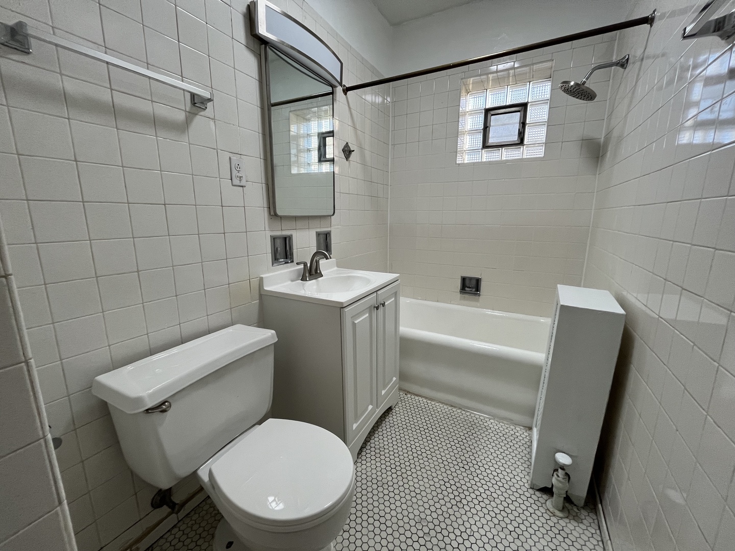 Undisclosed Address Chicago, IL 60625 - Photo 7 of 13 a white toilet sitting next to a bathroom sink