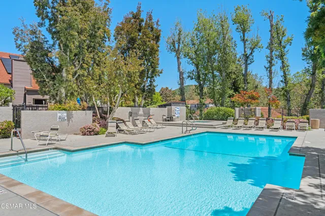 a view of a swimming pool with lounge chairs