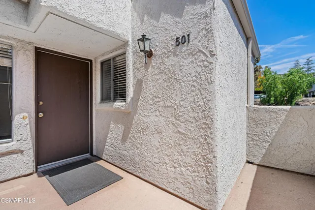 a view of a big room with wooden floor and windows