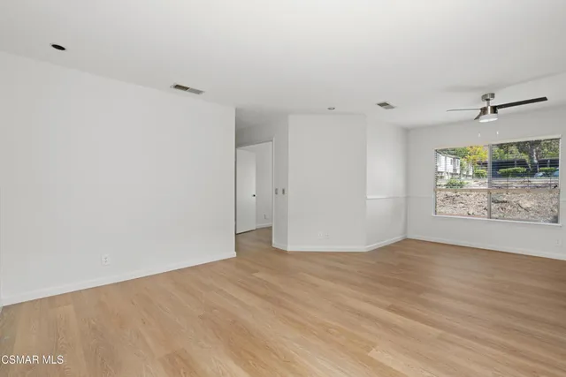 a kitchen with stainless steel appliances a refrigerator sink and white cabinets