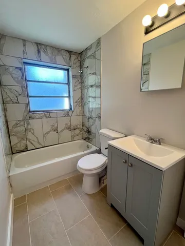 a bathroom with a sink a toilet and bathtub