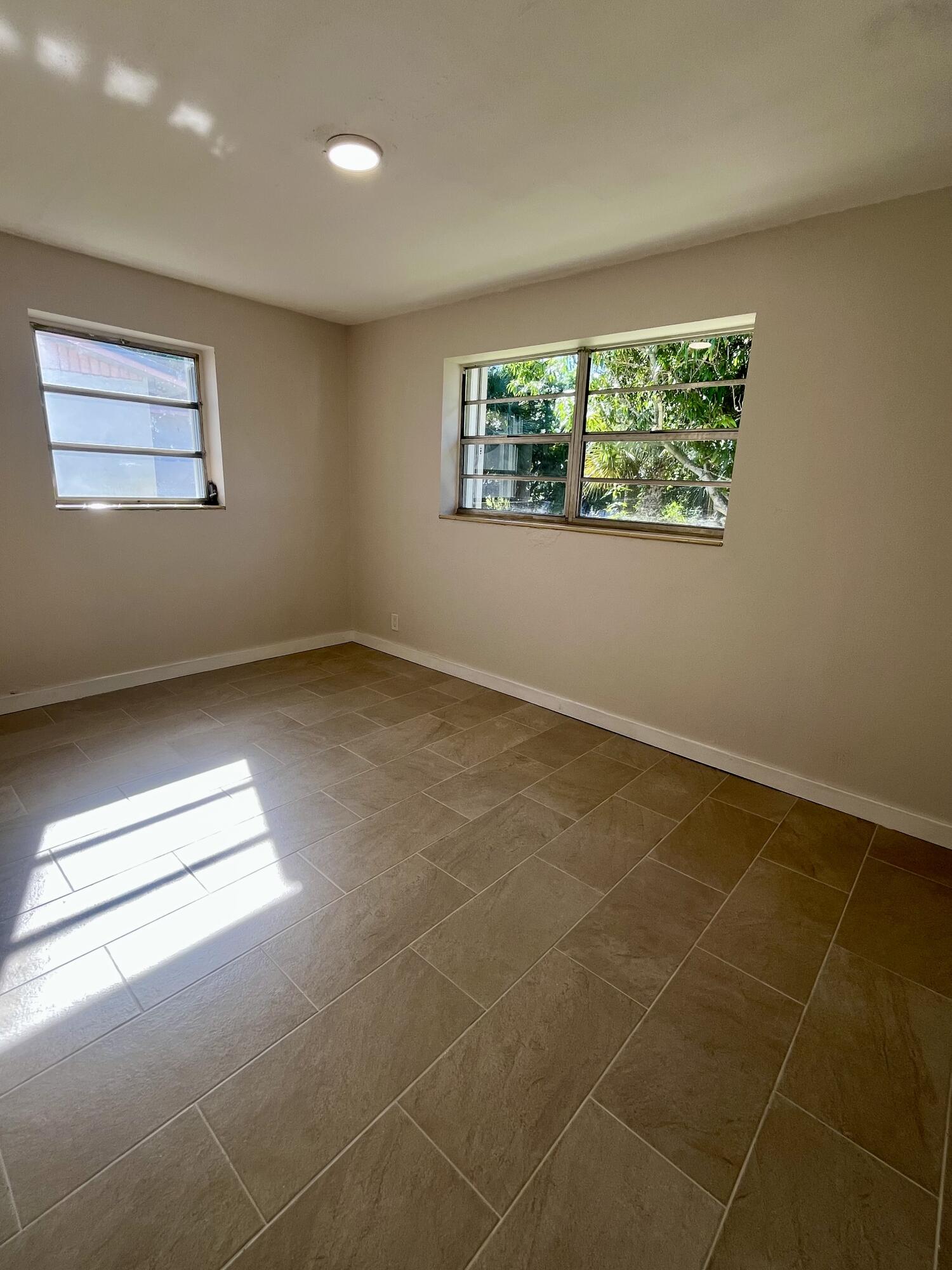 725 West 9th Street Riviera Beach, FL 33404 - Photo 6 of 6 a view of an empty room with a window