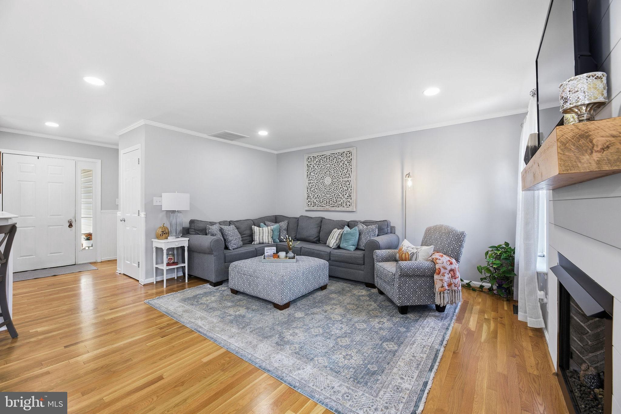 1719 Lottie Fowler Road Prince Frederick, MD 20678 - Photo 14 of 62 a living room with furniture and a fireplace