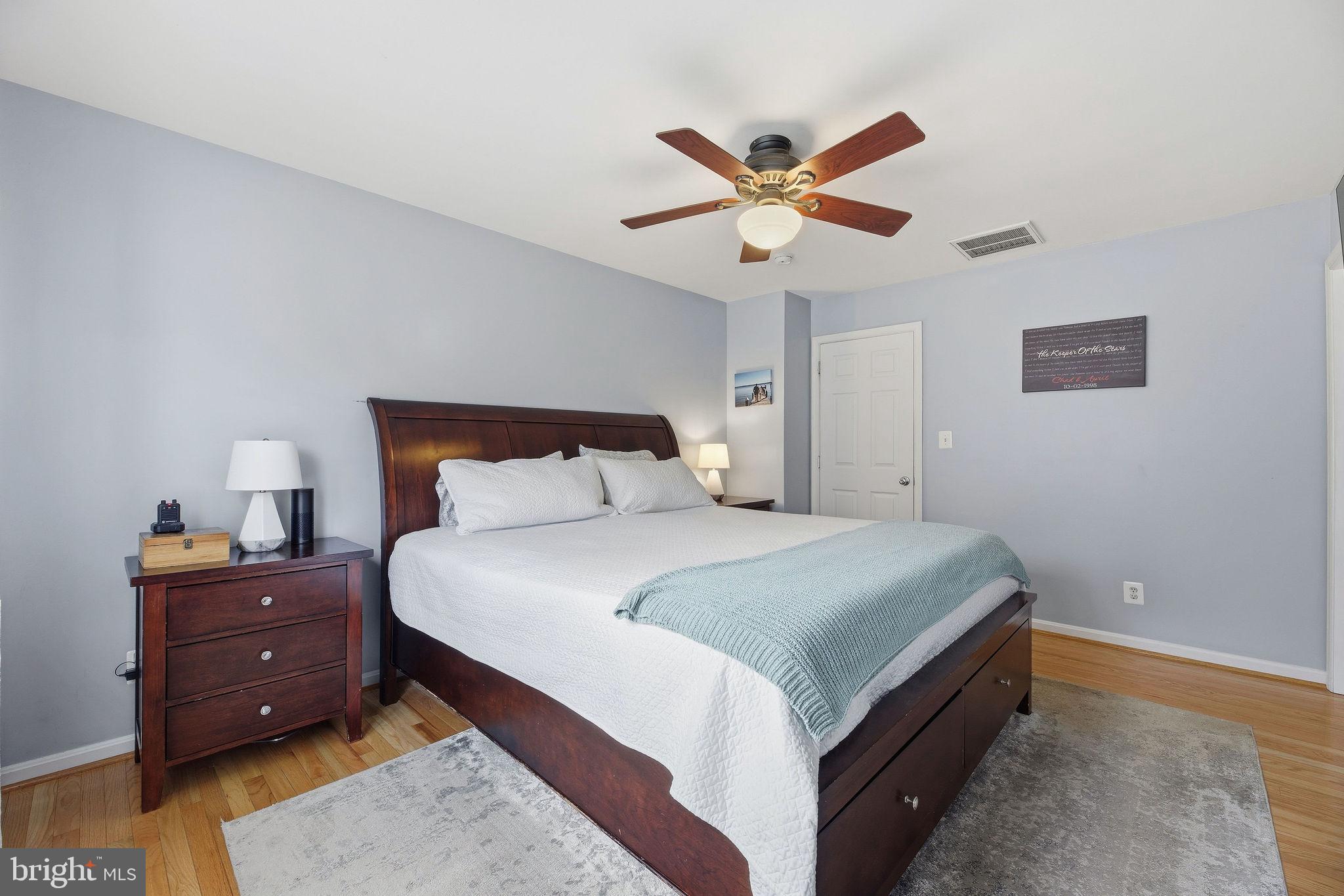 1719 Lottie Fowler Road Prince Frederick, MD 20678 - Photo 17 of 62 a bedroom with a bed and a chandelier