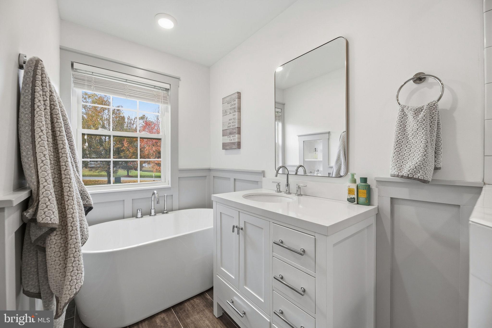 1719 Lottie Fowler Road Prince Frederick, MD 20678 - Photo 19 of 62 a bathroom with a tub sink and mirror