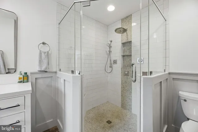 a bathroom with a sink a toilet and shower