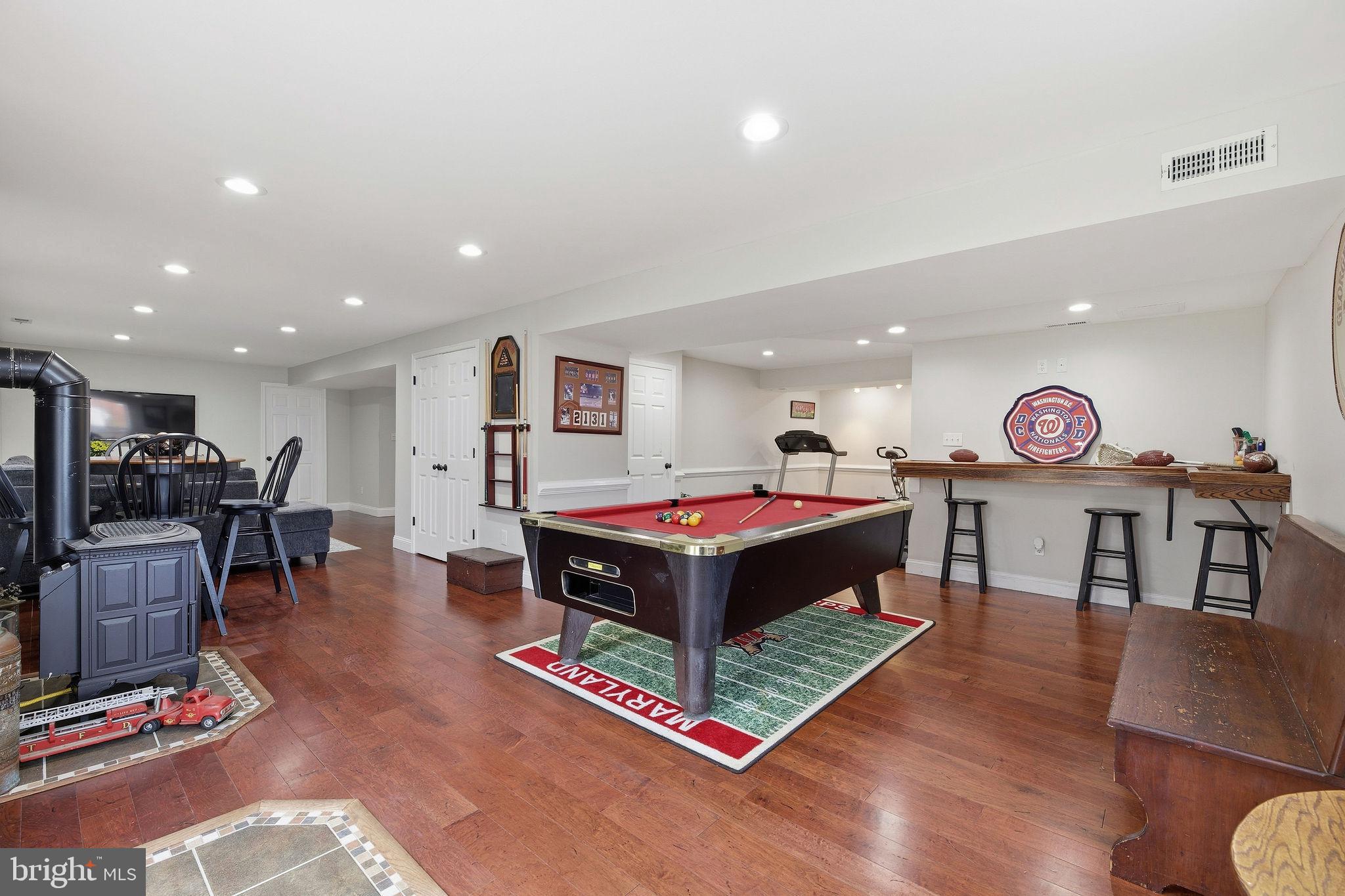 1719 Lottie Fowler Road Prince Frederick, MD 20678 - Photo 34 of 62 a living room with furniture a pool table and a flat screen tv