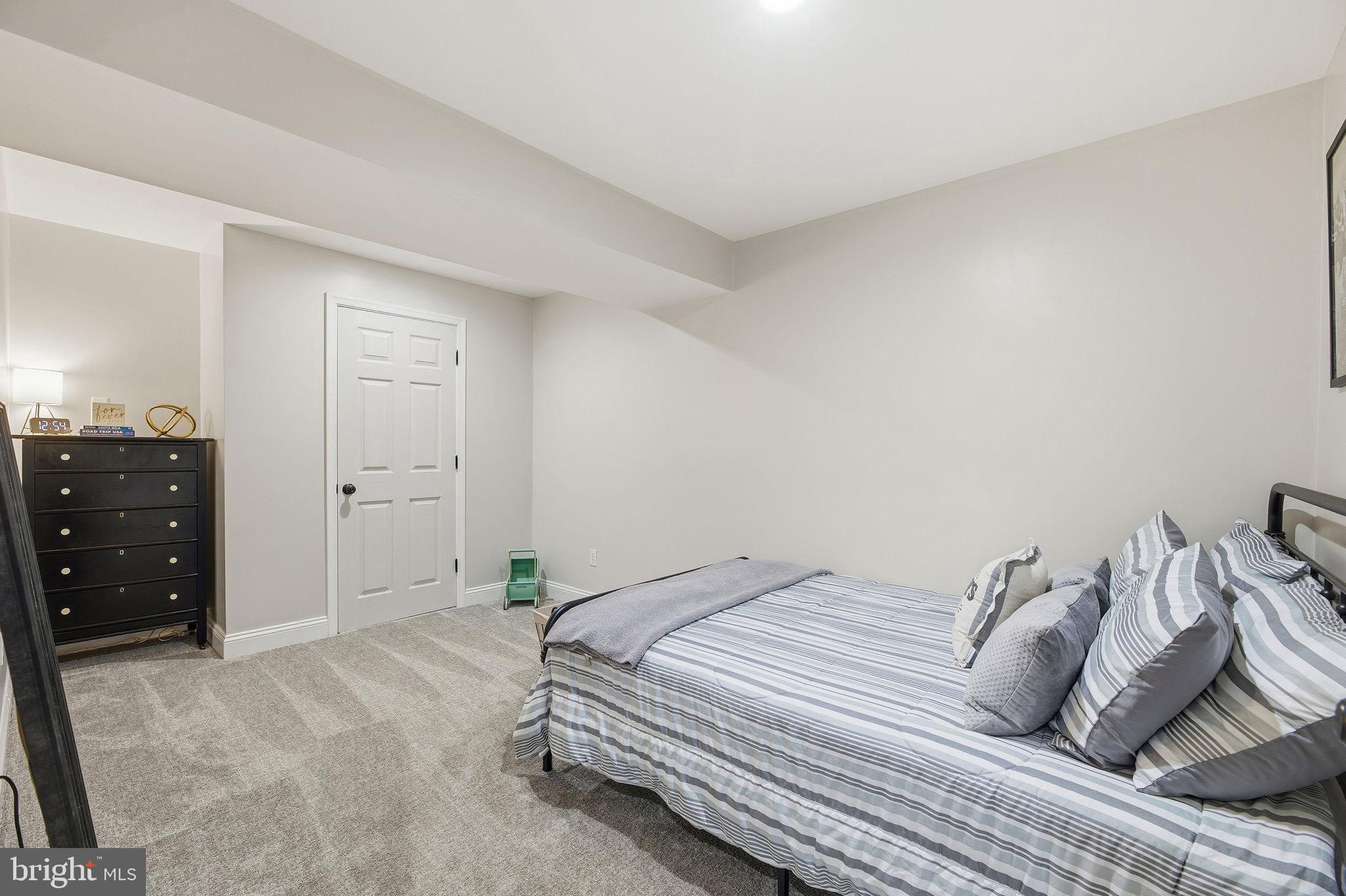 1719 Lottie Fowler Road Prince Frederick, MD 20678 - Photo 37 of 62 a bedroom with a bed and a cabinets