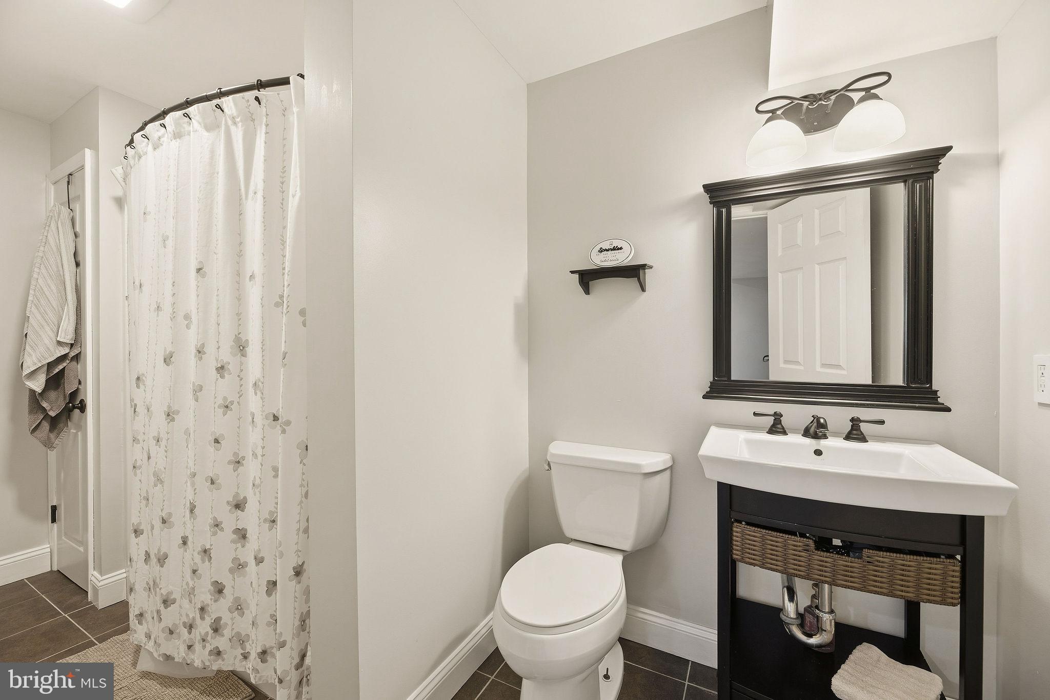 1719 Lottie Fowler Road Prince Frederick, MD 20678 - Photo 38 of 62 a bathroom with a sink toilet and shower