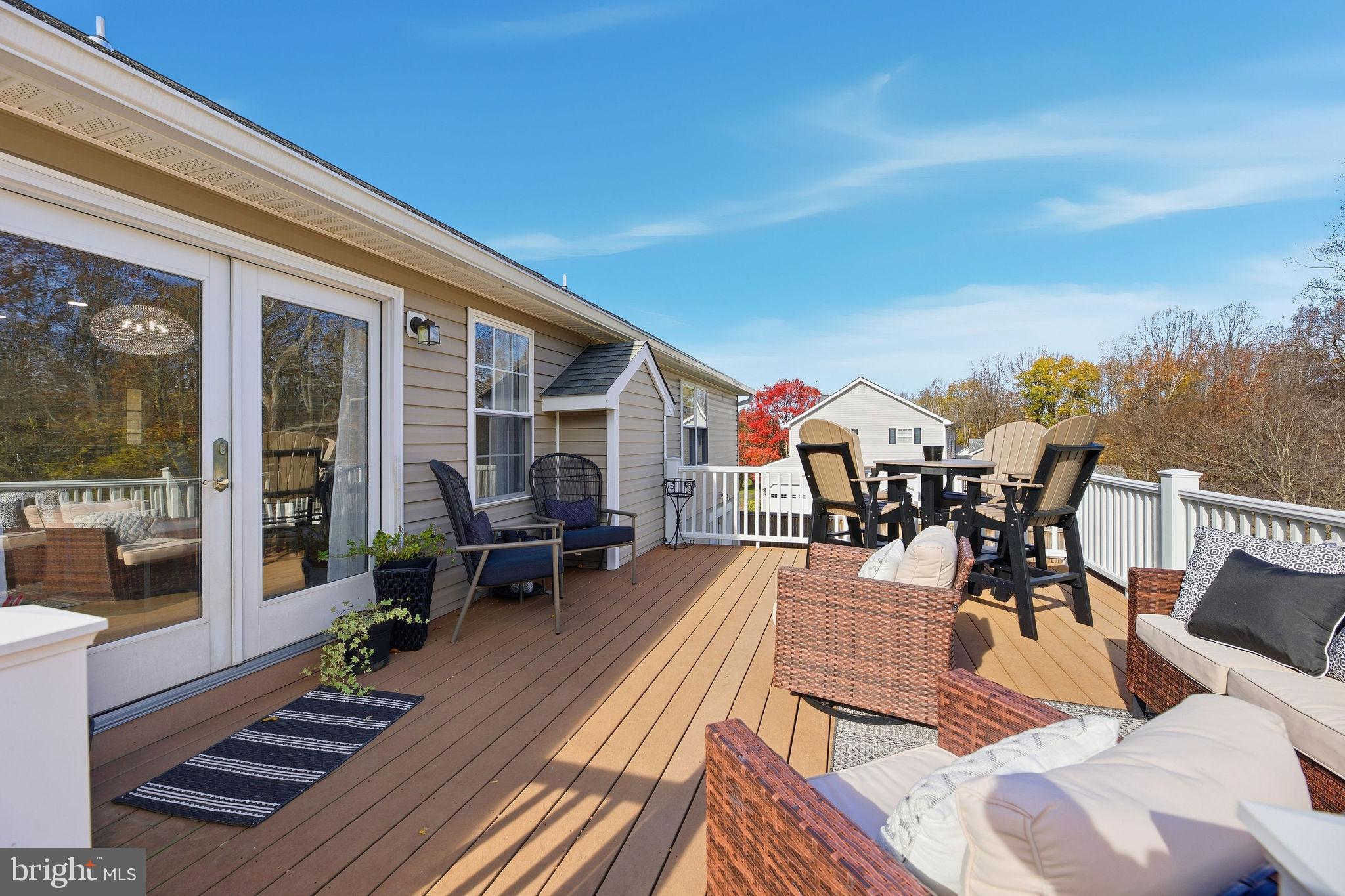 1719 Lottie Fowler Road Prince Frederick, MD 20678 - Photo 40 of 62 a view of a patio with dining table and chairs with wooden floor and fence