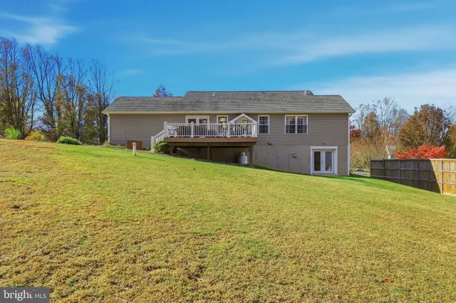 a view of a swimming pool with an ocean and trees in the background