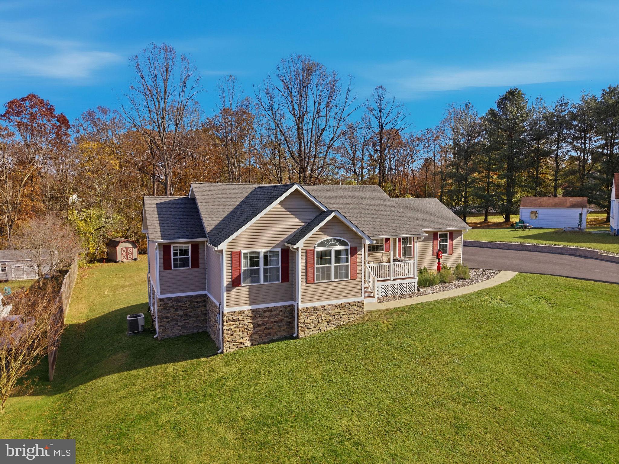 1719 Lottie Fowler Road Prince Frederick, MD 20678 - Photo 56 of 62 a front view of a house with a yard and garage