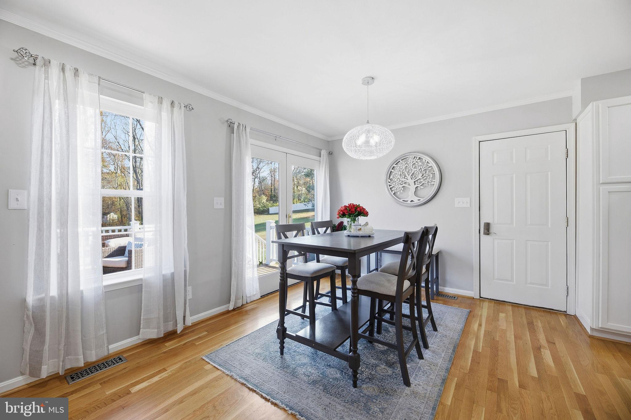 1719 Lottie Fowler Road Prince Frederick, MD 20678 - Photo 10 of 62 a view of a dining room and livingroom with furniture window and wooden floor