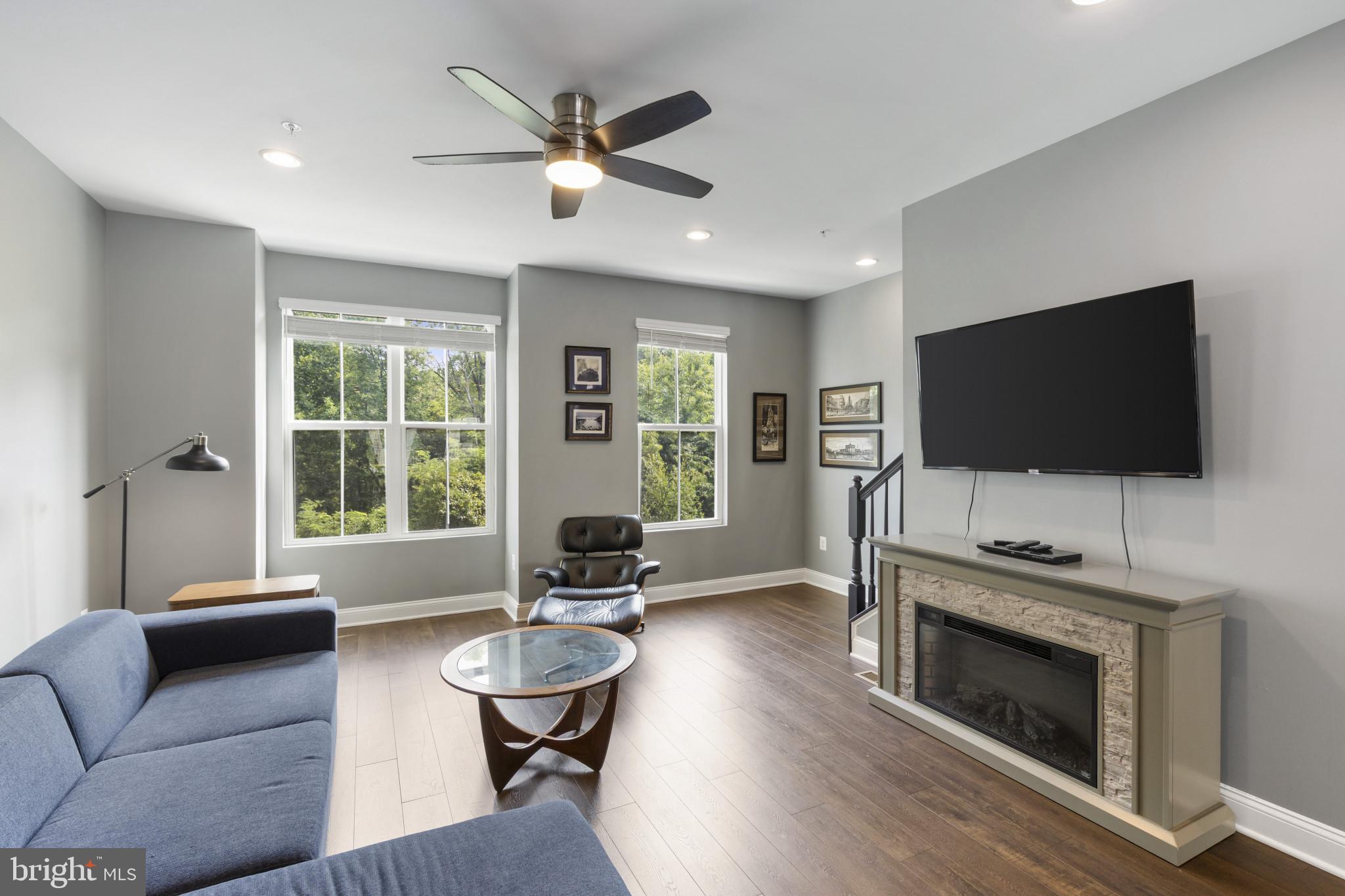 7107 Littlemore Way Hanover, MD 21076 - Photo 11 of 39 a living room with furniture a flat screen tv and a fireplace