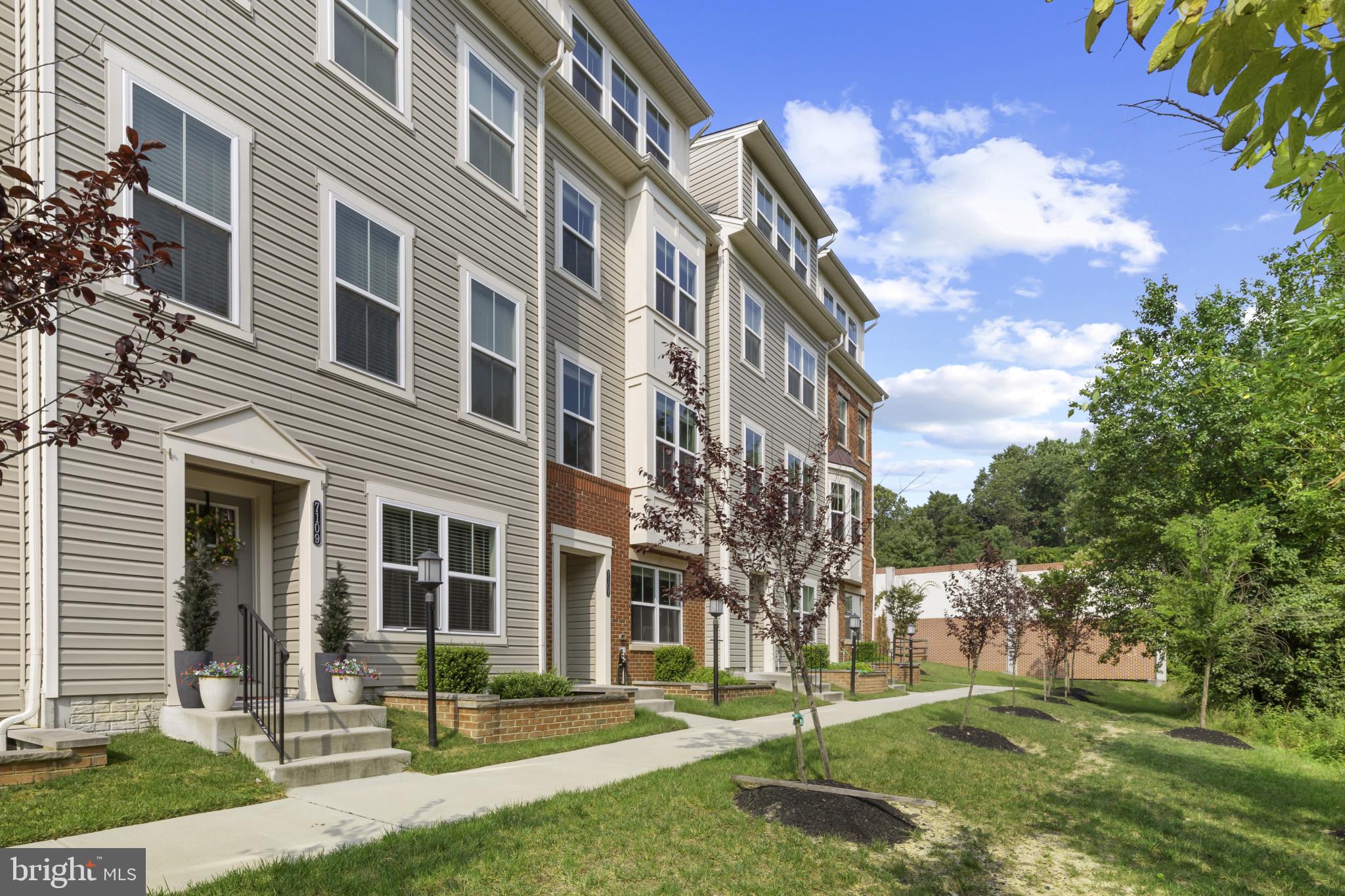 7107 Littlemore Way Hanover, MD 21076 - Photo 2 of 39 front view of a building with a yard