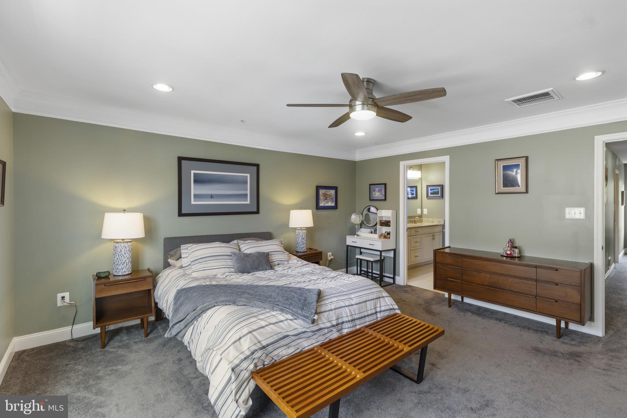 7107 Littlemore Way Hanover, MD 21076 - Photo 22 of 39 a bedroom with a bed and a chandelier