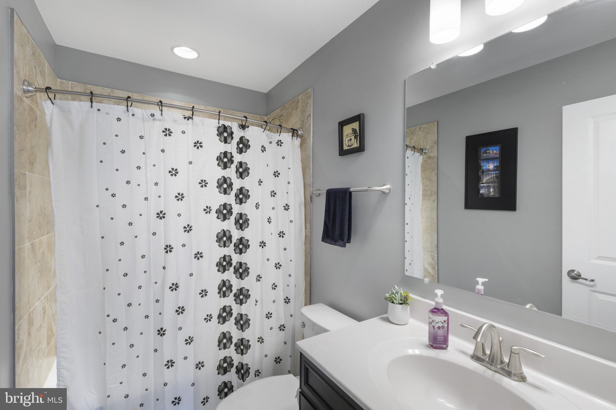 7107 Littlemore Way Hanover, MD 21076 - Photo 28 of 39 a bathroom with a sink toilet and shower