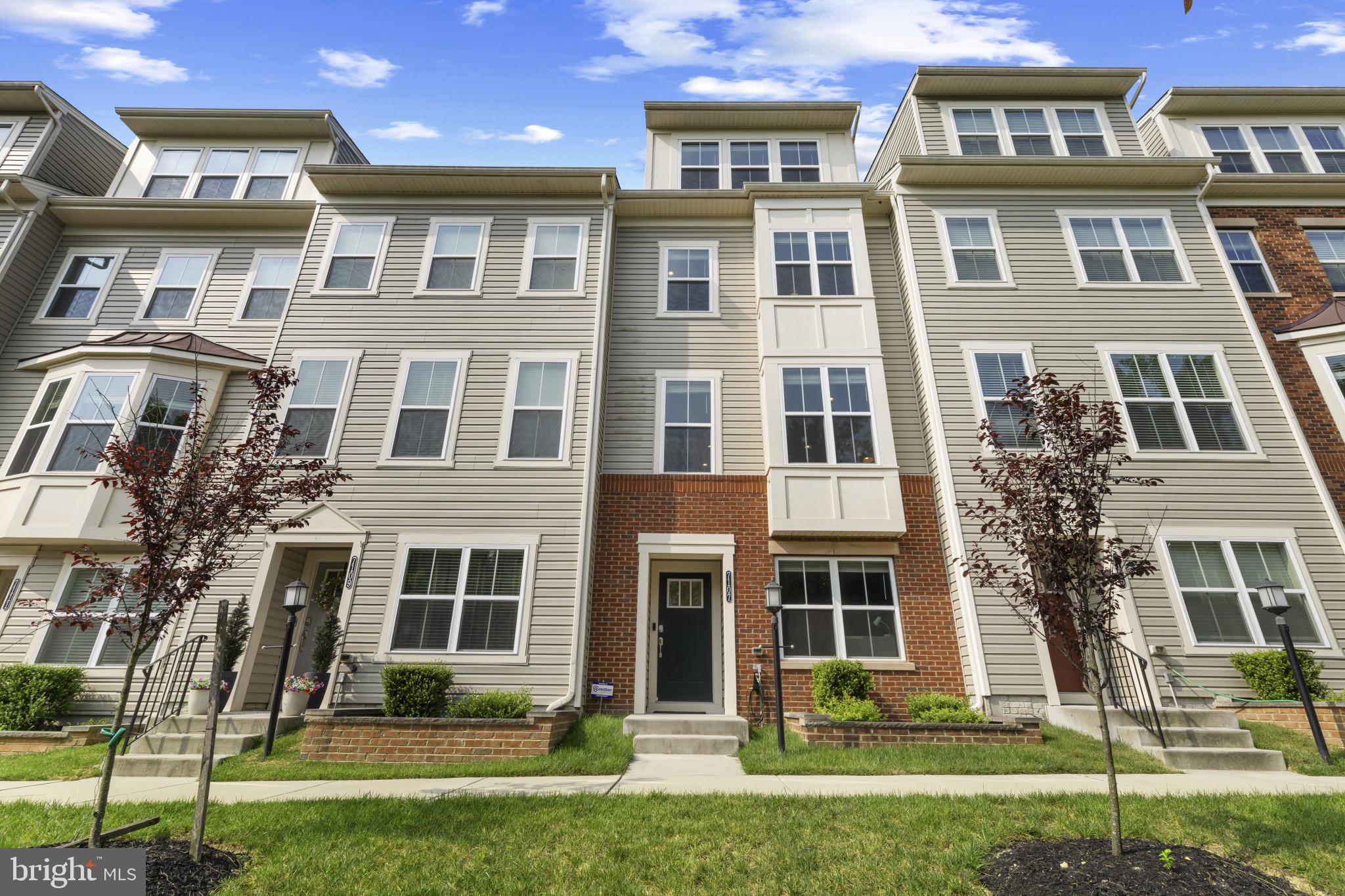 7107 Littlemore Way Hanover, MD 21076 - Photo 3 of 39 a front view of a residential apartment building with a yard