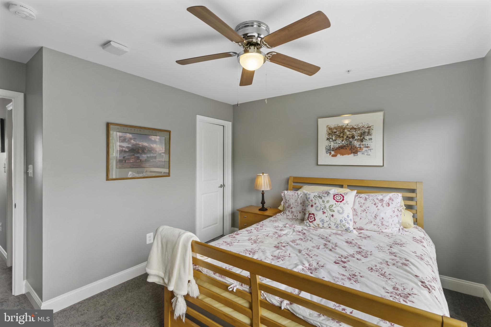 7107 Littlemore Way Hanover, MD 21076 - Photo 34 of 39 a bedroom with bed and paintings on the wall