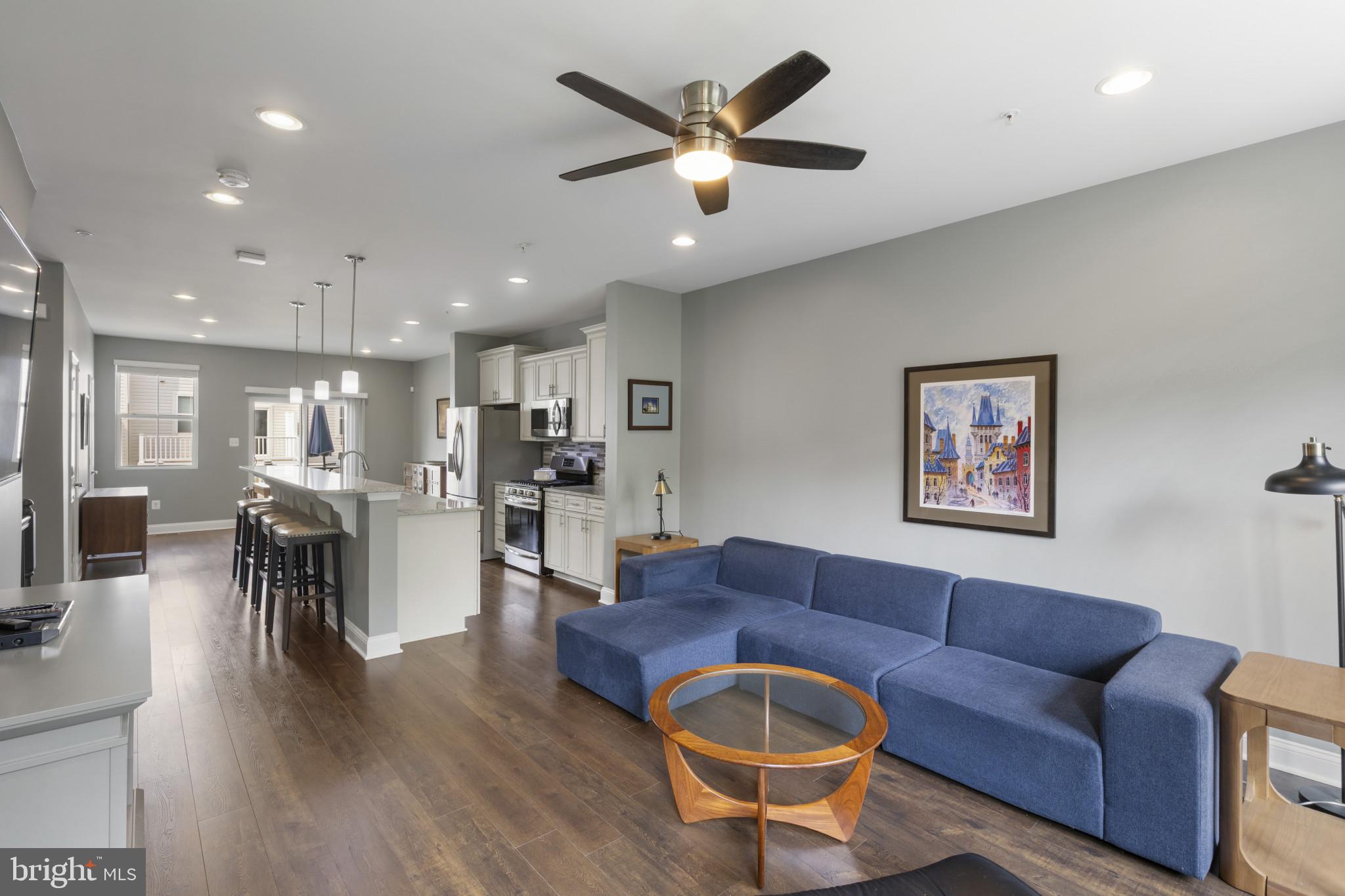 7107 Littlemore Way Hanover, MD 21076 - Photo 10 of 39 a living room with furniture kitchen view and a wooden floor