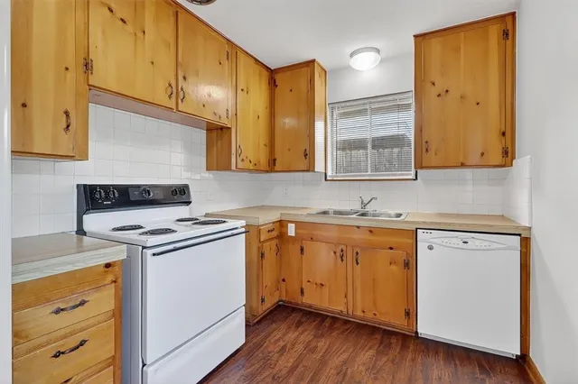 a kitchen with a sink stove and cabinets