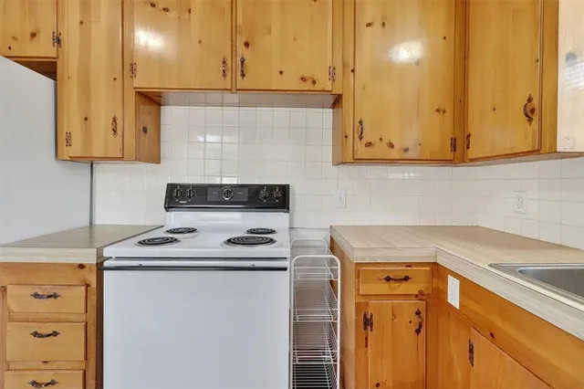 a kitchen with stainless steel appliances granite countertop a sink stove and cabinets