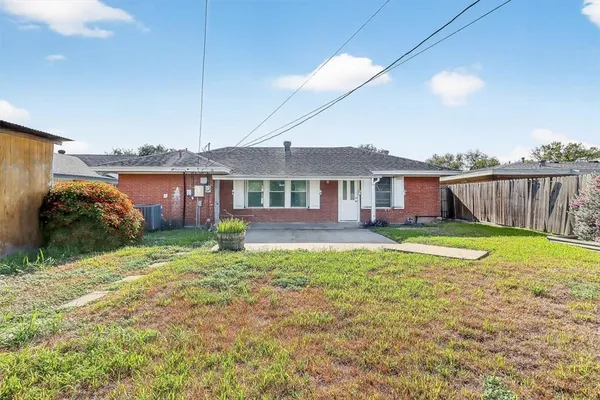 a view of an house with backyard space and balcony