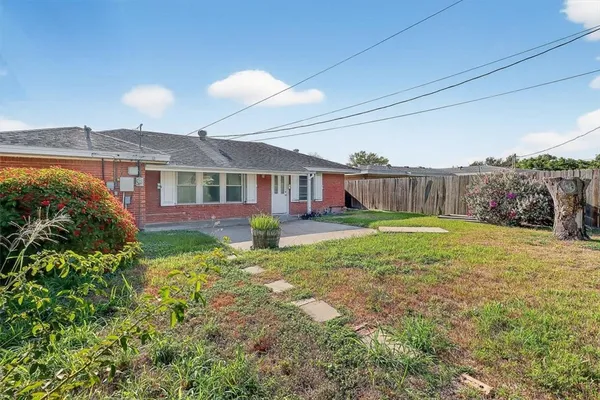 a view of a backyard with plants and a garden