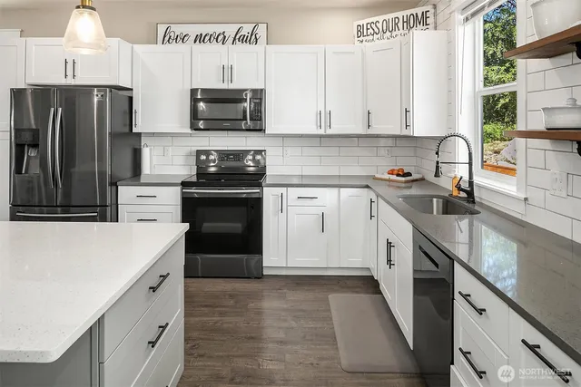 a kitchen with stainless steel appliances a stove sink and refrigerator