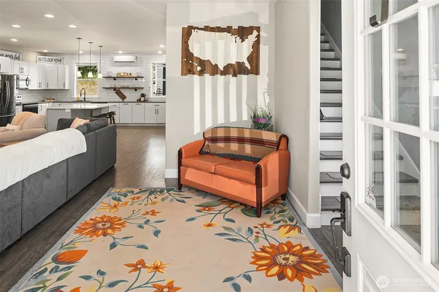 a living room with furniture and a rug