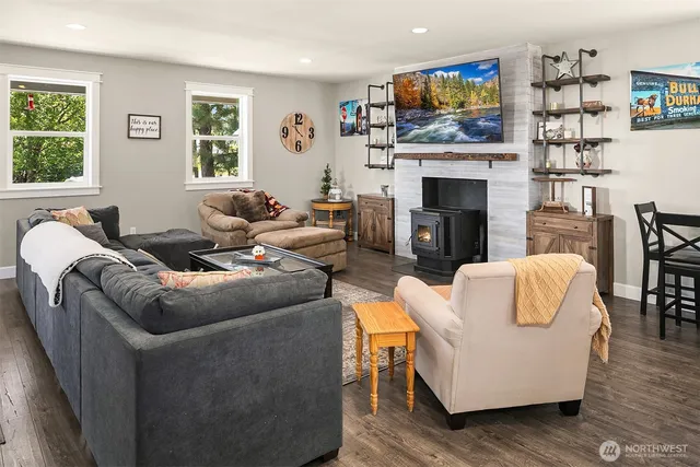 a living room with fireplace furniture and a flat screen tv
