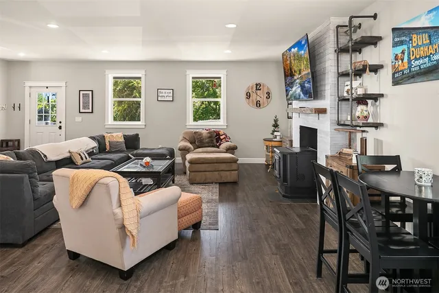 a living room with fireplace furniture and a window