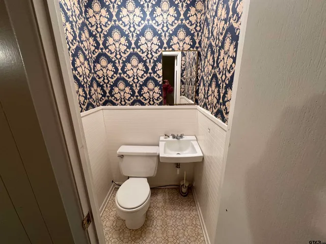 a white toilet sitting next to a sink