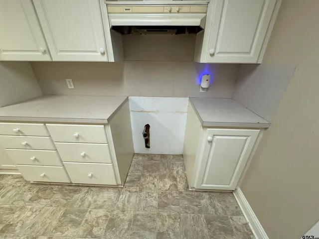 a view of storage and utility room with cabinet