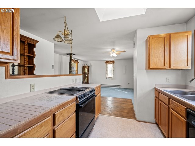 387 East Linden Way Heppner, OR 97836 - Photo 11 of 37 a kitchen with stainless steel appliances granite countertop a stove a sink dishwasher and cabinets with wooden floor