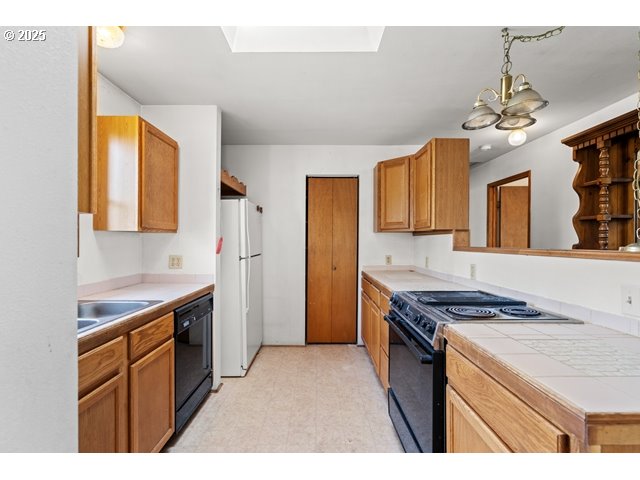 387 East Linden Way Heppner, OR 97836 - Photo 8 of 37 a kitchen with stainless steel appliances granite countertop a stove cabinets and entryway