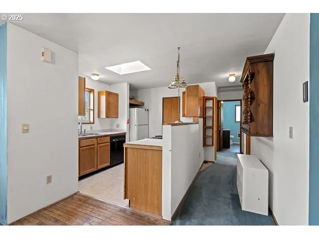 a open kitchen with cabinets a stove and a refrigerator