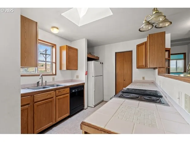 a kitchen with a sink appliances and cabinets