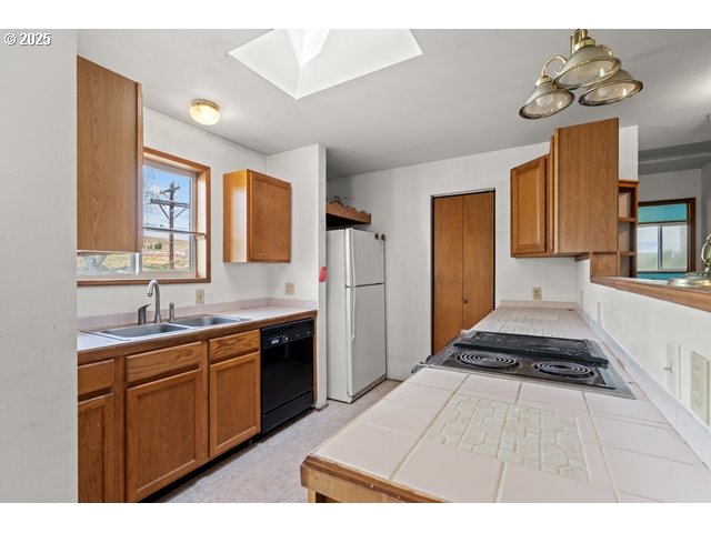 387 East Linden Way Heppner, OR 97836 - Photo 10 of 37 a kitchen with a sink appliances and cabinets