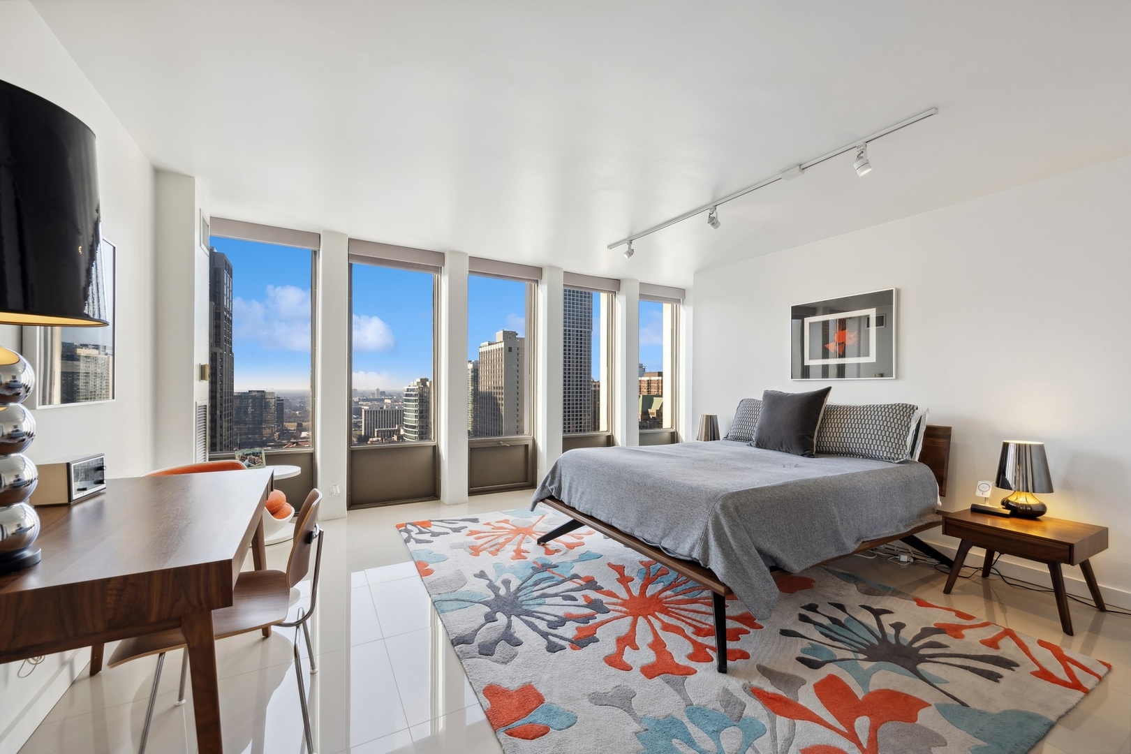 100 East Walton Street, Unit 32FG Chicago, IL 60611 - Photo 12 of 30 a bedroom with a bed and large windows